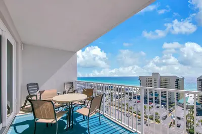 a balcony with a table and chairs and the ocean at Laketown Wharf 1116 in Panama City Beach