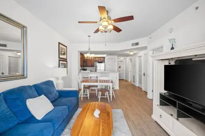 a living room with a blue couch and a tv at Seychelles Unit 1205 in Panama City Beach