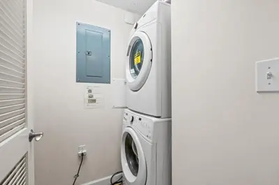 a washing machine in a bathroom with a window at Seychelles Unit 1205 in Panama City Beach