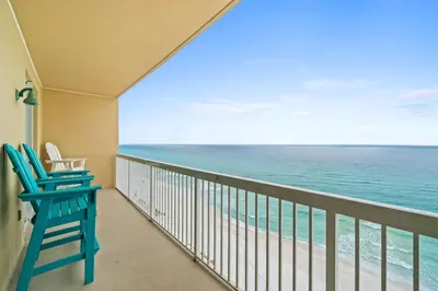 a balcony with two chairs and the ocean at Seychelles Unit 1205 in Panama City Beach