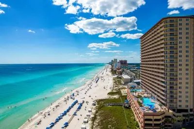 a view of a beach with people and the ocean at 21st-Floor Sunrise Beach Gulf-Front Condo w/ Bunks & Panoramic Views in Panama City Beach