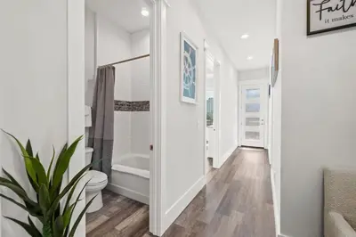 a white bathroom with a toilet and a sink at New 6BR Home Sleeps 20 | Private Pool, Walk to Beach, Near Pier Park in Panama City Beach