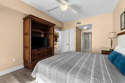 a bedroom with a bed and a flat screen tv at Sunrise Beach 14th-Floor Gulf-Front Condo w/ Pools, Bunks & Balcony Views in Panama City Beach