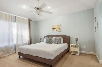 a bedroom with a bed and a ceiling fan at Large Pet-Friendly Beach Home | Sleeps 14 Near Pier Park in Panama City Beach