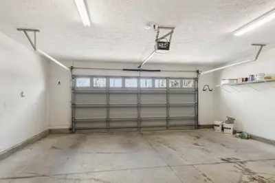 an empty garage with a garage door and a garage at Large Pet-Friendly Beach Home | Sleeps 14 Near Pier Park in Panama City Beach