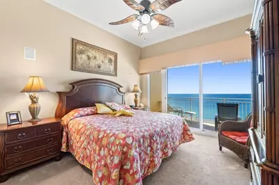 a bedroom with a bed and a view of the ocean at Sunrise Beach 14th-Floor Gulf-Front Condo Pools, Bunks & Balcony Views in Panama City Beach