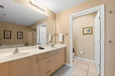 a bathroom with a sink and a large mirror at Sunrise Beach 14th-Floor Gulf-Front Condo Pools, Bunks & Balcony Views in Panama City Beach