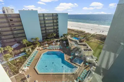 an aerial view of a hotel with a pool and the beach at Top of the Gulf 620 Beachfront Couples Retreat in Panama City Beach