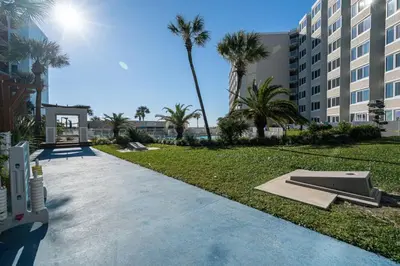 a skateboard park with palm trees and a building at Top of the Gulf 620 Beachfront Couples Retreat in Panama City Beach