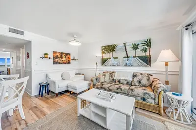 a living room with a couch and a table at Stunning condo in Pinnacle Port, Panama City Beach in Panama City Beach