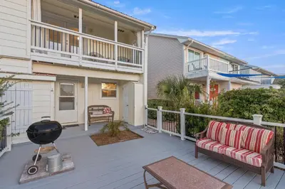 a patio with a couch and a grill in front of a house at SeaRenity Awaits: 2-BD, 2-BA Coastal Escape! Perfect for 5! Pet Friendly! in Laguna Beach