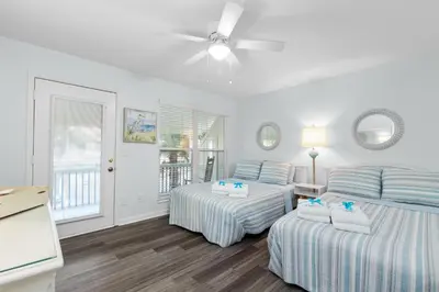a bedroom with two beds and a ceiling fan at SeaRenity Awaits: 2-BD, 2-BA Coastal Escape! Perfect for 5! Pet Friendly! in Laguna Beach