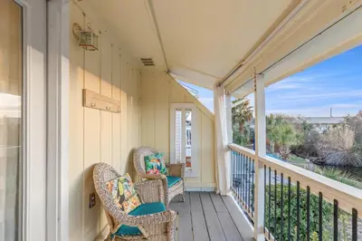 a porch with wicker chairs and a view of the ocean at SeaRenity Awaits: 2-BD, 2-BA Coastal Escape! Perfect for 5! Pet Friendly! in Laguna Beach