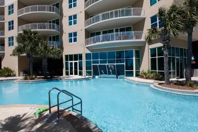 a large swimming pool in front of a building at Aqua Beach Resort by Panhandle Getaways in Panama City Beach