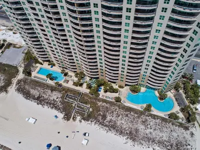 an aerial view of a pool in front of tall buildings at Aqua Beach Resort by Panhandle Getaways in Panama City Beach