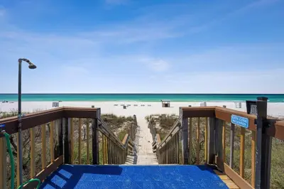 a boardwalk leading to a beach with the ocean at AquaVista Beach Resort by Panhandle Getaways in Panama City Beach