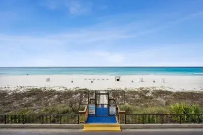 a slide on the beach with the beach in the background at AquaVista Beach Resort by Panhandle Getaways in Panama City Beach