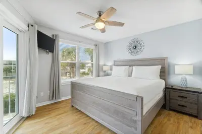 a bedroom with a bed and a ceiling fan at Beachside Villas by Panhandle Getaways in Seagrove Beach