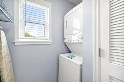 a bathroom with a washer and dryer and a window at Beachside Villas by Panhandle Getaways in Seagrove Beach