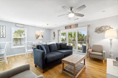 a living room with a couch and a table at Beachside Villas by Panhandle Getaways in Seagrove Beach