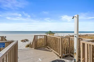 a boardwalk leading to the beach at a vacation rental at Boardwalk Beach Resort by Panhandle Getaways in Panama City Beach