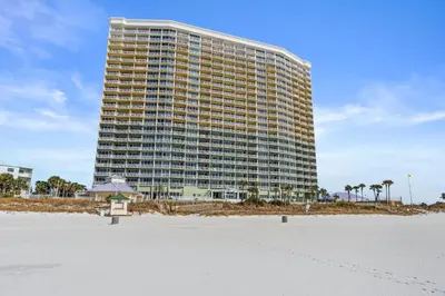 a tall building with a beach in front of it at Boardwalk Beach Resort by Panhandle Getaways in Panama City Beach