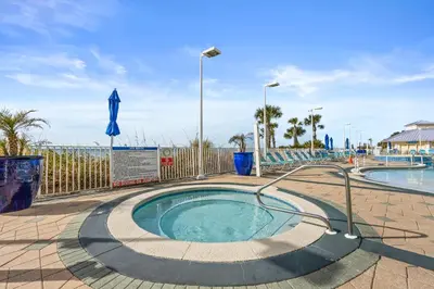 a swimming pool with a hot tub at Boardwalk Beach Resort by Panhandle Getaways in Panama City Beach