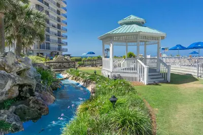 a gazebo next to a river in a park at Edgewater Beach & Golf Resort by Panhandle Getaways in Panama City Beach