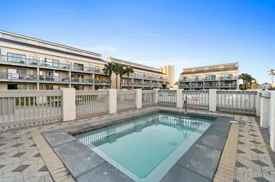 a swimming pool in front of a building at Endless Summer by Panhandle Getaways in Panama City Beach