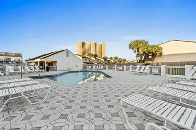 a swimming pool with chaise lounge chairs and a resort at Endless Summer by Panhandle Getaways in Panama City Beach