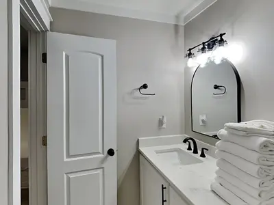 a white bathroom with a sink and a mirror at Easy on Eastern Lake in Santa Rosa Beach