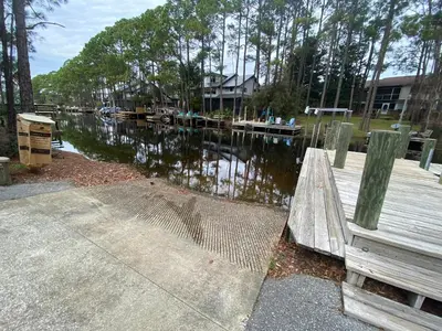 a view of a river with a wooden dock at Easy on Eastern Lake in Santa Rosa Beach