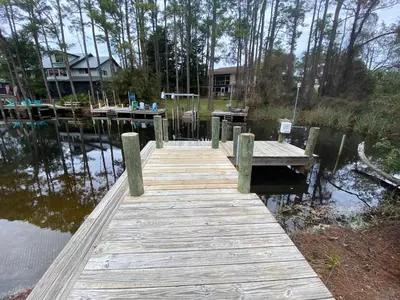 a wooden dock in the middle of a lake at Easy on Eastern Lake in Santa Rosa Beach