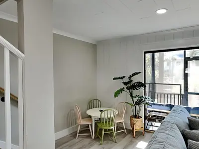 a living room with a couch and a table at Easy on Eastern Lake in Santa Rosa Beach