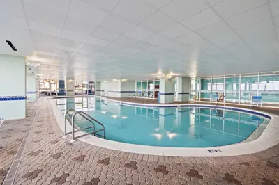 a large swimming pool in a large building at Majestic Beach Towers Resort by Panhandle Getaways in Panama City Beach