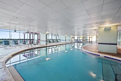 a swimming pool with blue water in a building at Majestic Beach Towers Resort by Panhandle Getaways in Panama City Beach