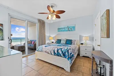 a bedroom with a bed and a ceiling fan at Ocean Ritz by Panhandle Getaways in Panama City Beach