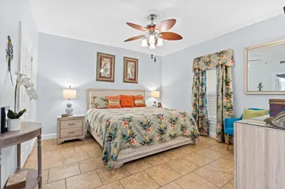 a bedroom with a bed and a ceiling fan at Ocean Ritz by Panhandle Getaways in Panama City Beach