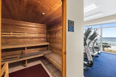 a gym with a sauna with a treadmill at Ocean Villa by Panhandle Getaways in Panama City Beach