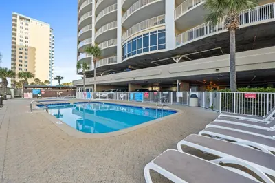 a swimming pool in front of a building at Ocean Villa by Panhandle Getaways in Panama City Beach