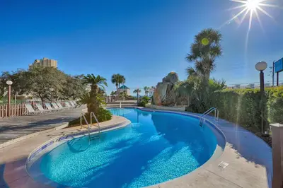 a swimming pool with blue water in a resort at Portside Resort by Panhandle Getaways in Panama City Beach