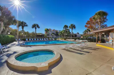 a large swimming pool with chairs and a swimming pool at Portside Resort by Panhandle Getaways in Panama City Beach