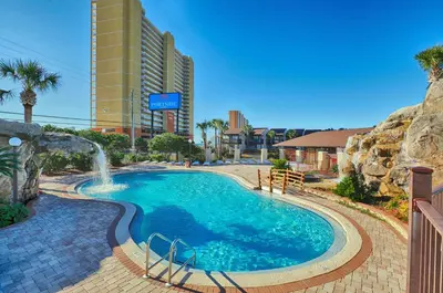 a swimming pool with a water fountain in a resort at Portside Resort by Panhandle Getaways in Panama City Beach