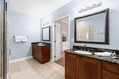 a bathroom with a sink and a mirror at Reflections by Panhandle Getaways in Panama City Beach
