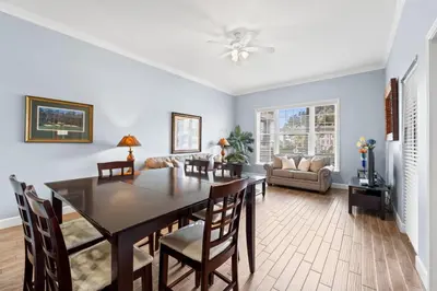 a dining room and living room with a table and chairs at Reflections by Panhandle Getaways in Panama City Beach