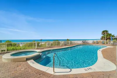 a swimming pool with the ocean in the background at Seychelles Resort by Panhandle Getaways in Panama City Beach