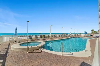 a swimming pool with the beach in the background at Seychelles Resort by Panhandle Getaways in Panama City Beach