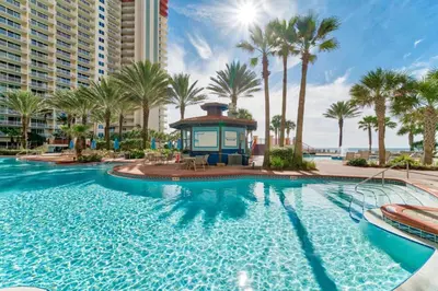 a pool at a resort with palm trees and a gazebo at Shores of Panama by Panhandle Getaways in Panama City Beach