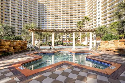 a swimming pool in front of a large building at Shores of Panama by Panhandle Getaways in Panama City Beach