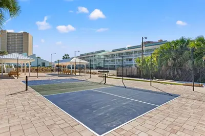 a tennis court in front of a building at Southwind by Panhandle Getaways in Panama City Beach
